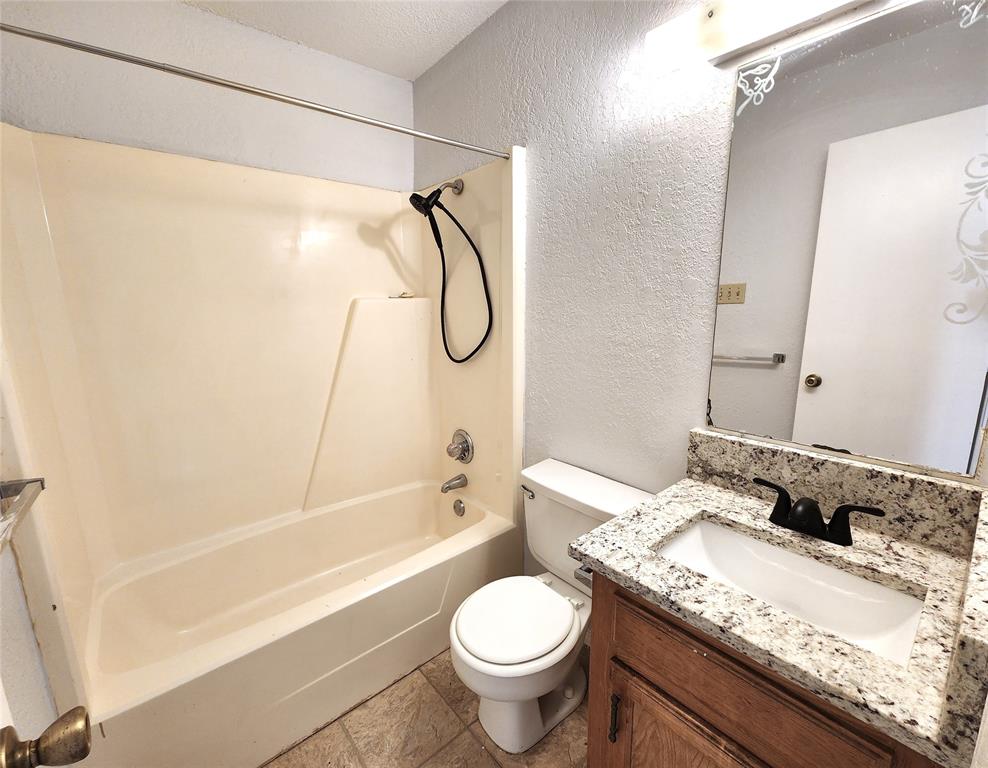 2202 Bolivar Street Denton, TX 76201 - Photo 30 of 36 a bathroom with a granite countertop sink toilet and shower