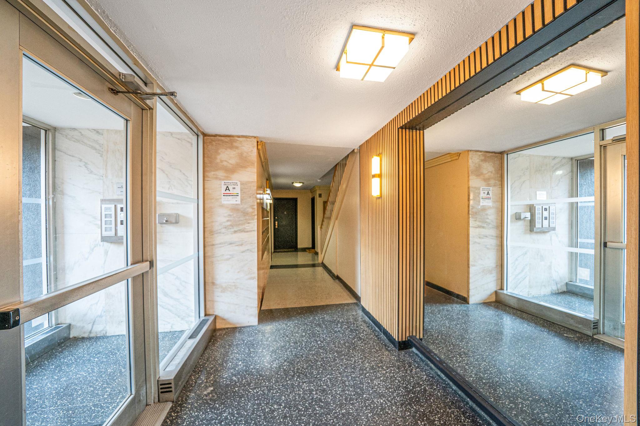 213-05 75th Avenue, Unit 4N Queens, NY 11364 - Photo 15 of 19 Corridor featuring speckled floor and a textured ceiling