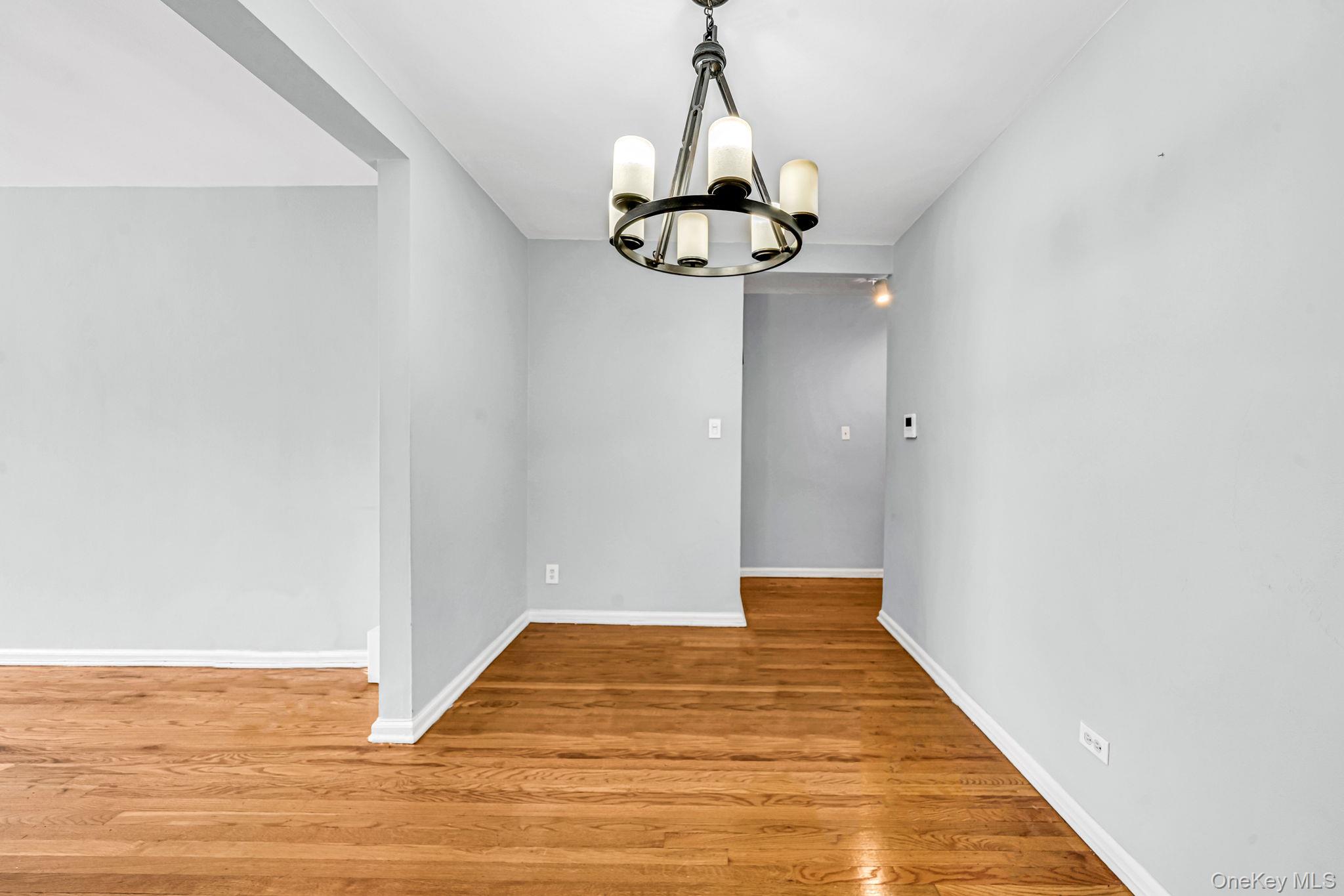 213-05 75th Avenue, Unit 4N Queens, NY 11364 - Photo 5 of 19 Spare room with light wood finished floors and a chandelier