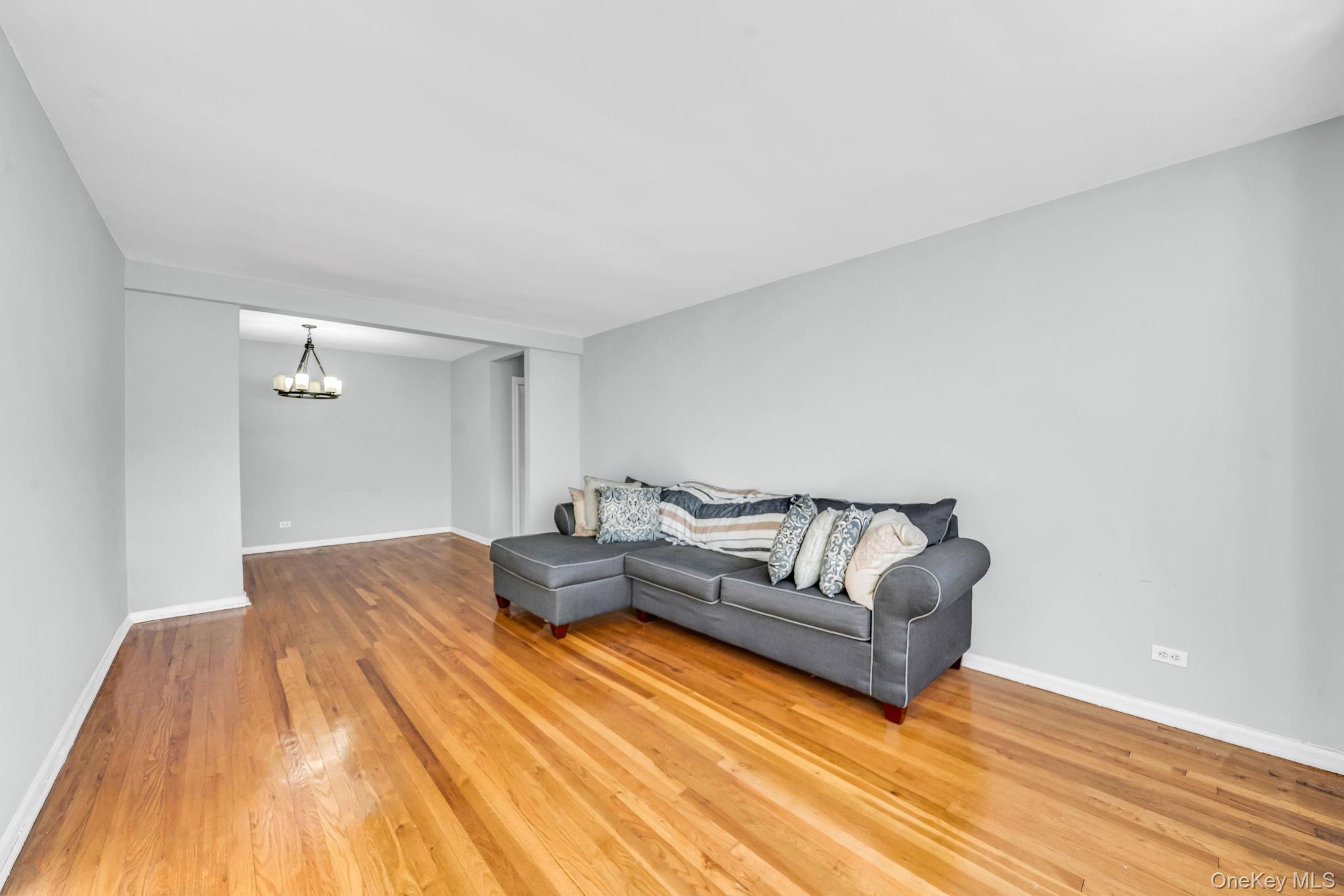 213-05 75th Avenue, Unit 4N Queens, NY 11364 - Photo 8 of 19 Living room featuring light wood-type flooring and a chandelier