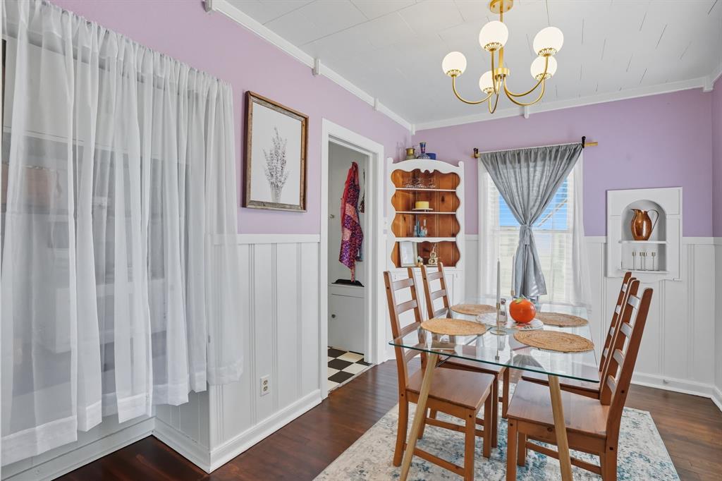 3244 Ryan Avenue Fort Worth, TX 76110 - Photo 12 of 31 a dining room with furniture a chandelier and wooden floor