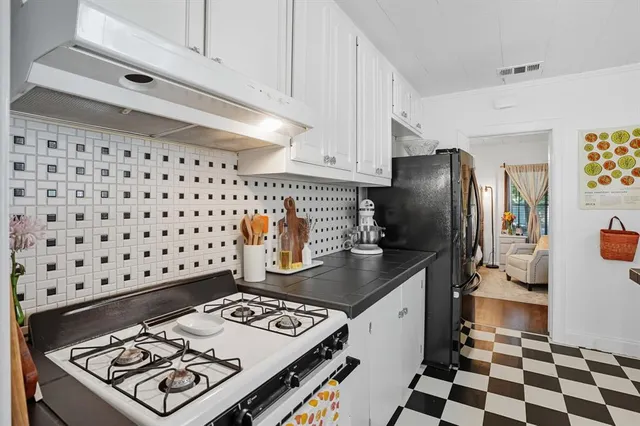 a kitchen with granite countertop a refrigerator and a stove