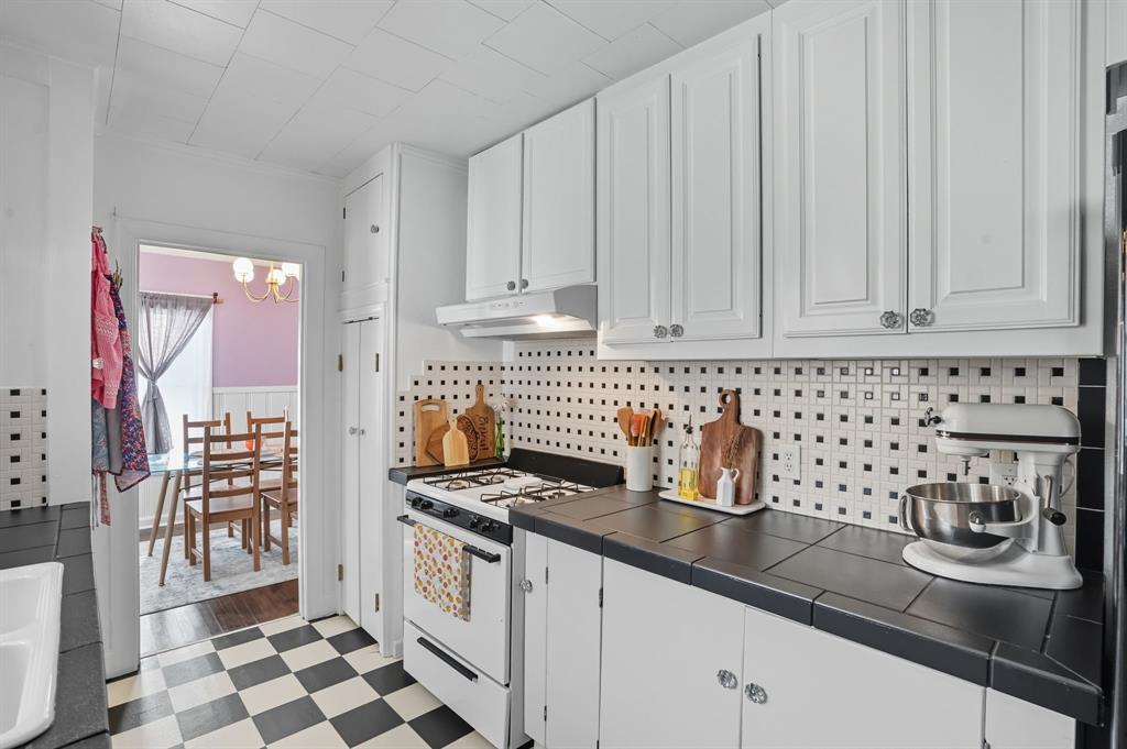 3244 Ryan Avenue Fort Worth, TX 76110 - Photo 15 of 31 a kitchen with granite countertop a sink a stove and cabinets
