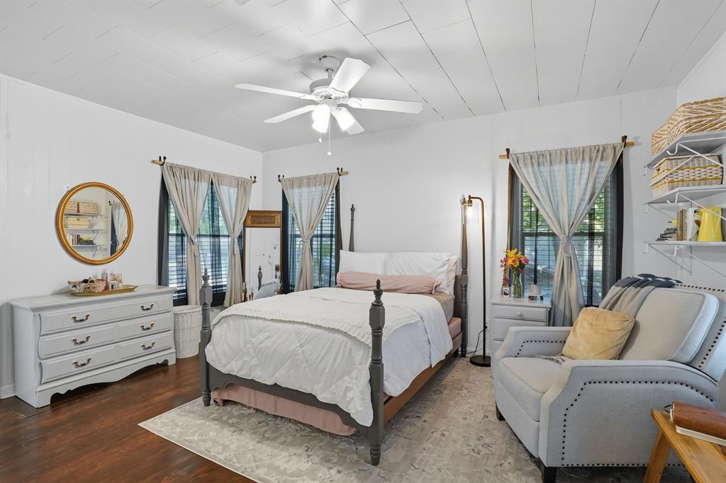 3244 Ryan Avenue Fort Worth, TX 76110 - Photo 19 of 31 a bedroom with a bed and a chandelier