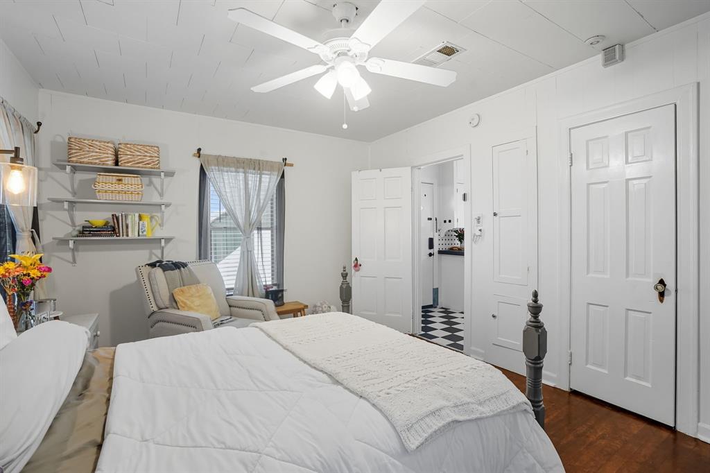 3244 Ryan Avenue Fort Worth, TX 76110 - Photo 21 of 31 a bedroom with a bed and a chandelier