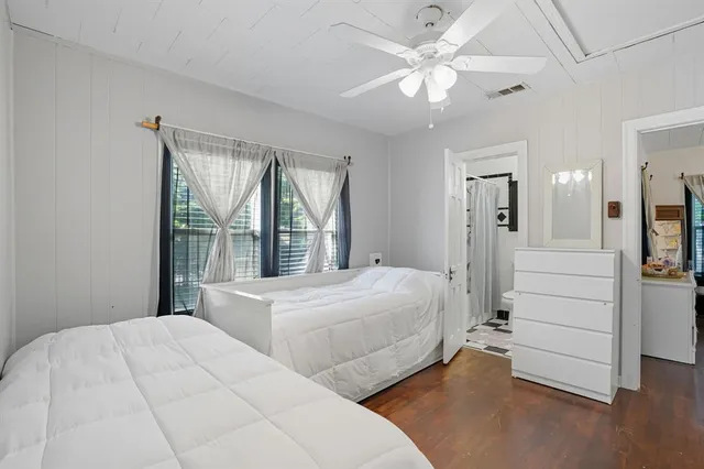 a bedroom with a large bed and a chandelier