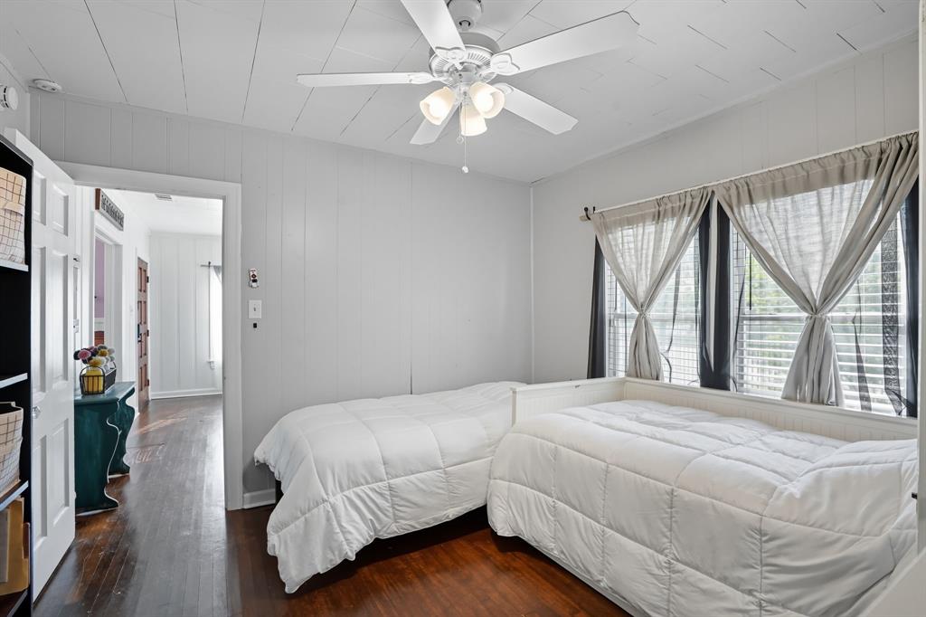 3244 Ryan Avenue Fort Worth, TX 76110 - Photo 25 of 31 a bedroom with a large bed and a chandelier