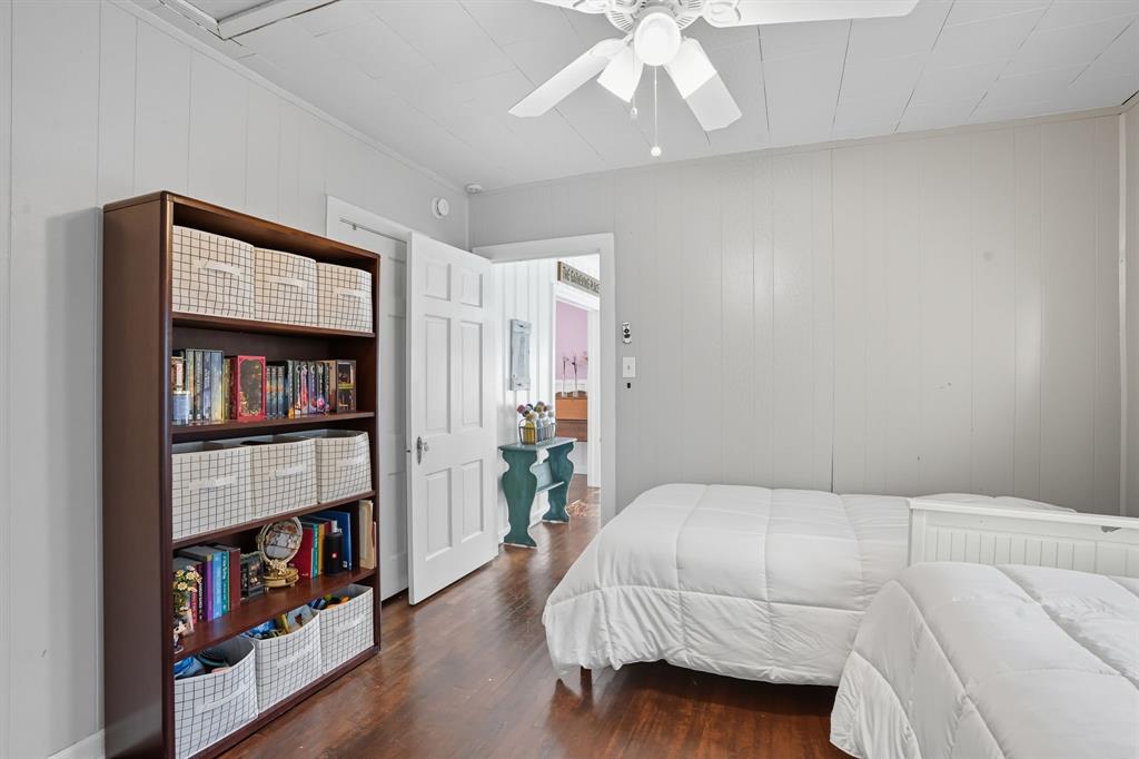 3244 Ryan Avenue Fort Worth, TX 76110 - Photo 26 of 31 a bedroom with a bed and a book shelf