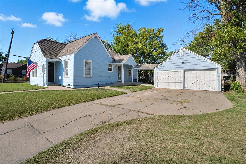 3244 Ryan Avenue Fort Worth, TX 76110 - Photo 4 of 31 a front view of a house with a yard and garage