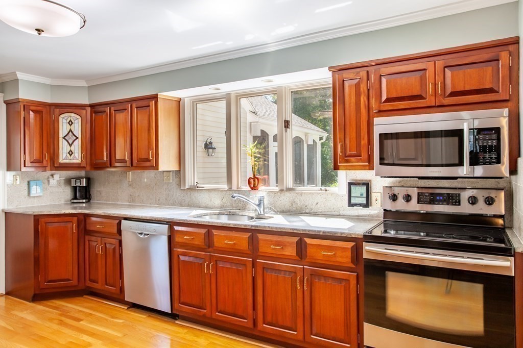 63 Dalton Road Chelmsford, MA 01824 - Photo 2 of 27 a kitchen with stainless steel appliances granite countertop a stove microwave and sink
