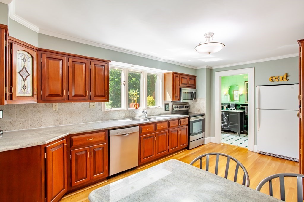 63 Dalton Road Chelmsford, MA 01824 - Photo 4 of 27 a large kitchen with kitchen island granite countertop a large window a sink and stainless steel appliances