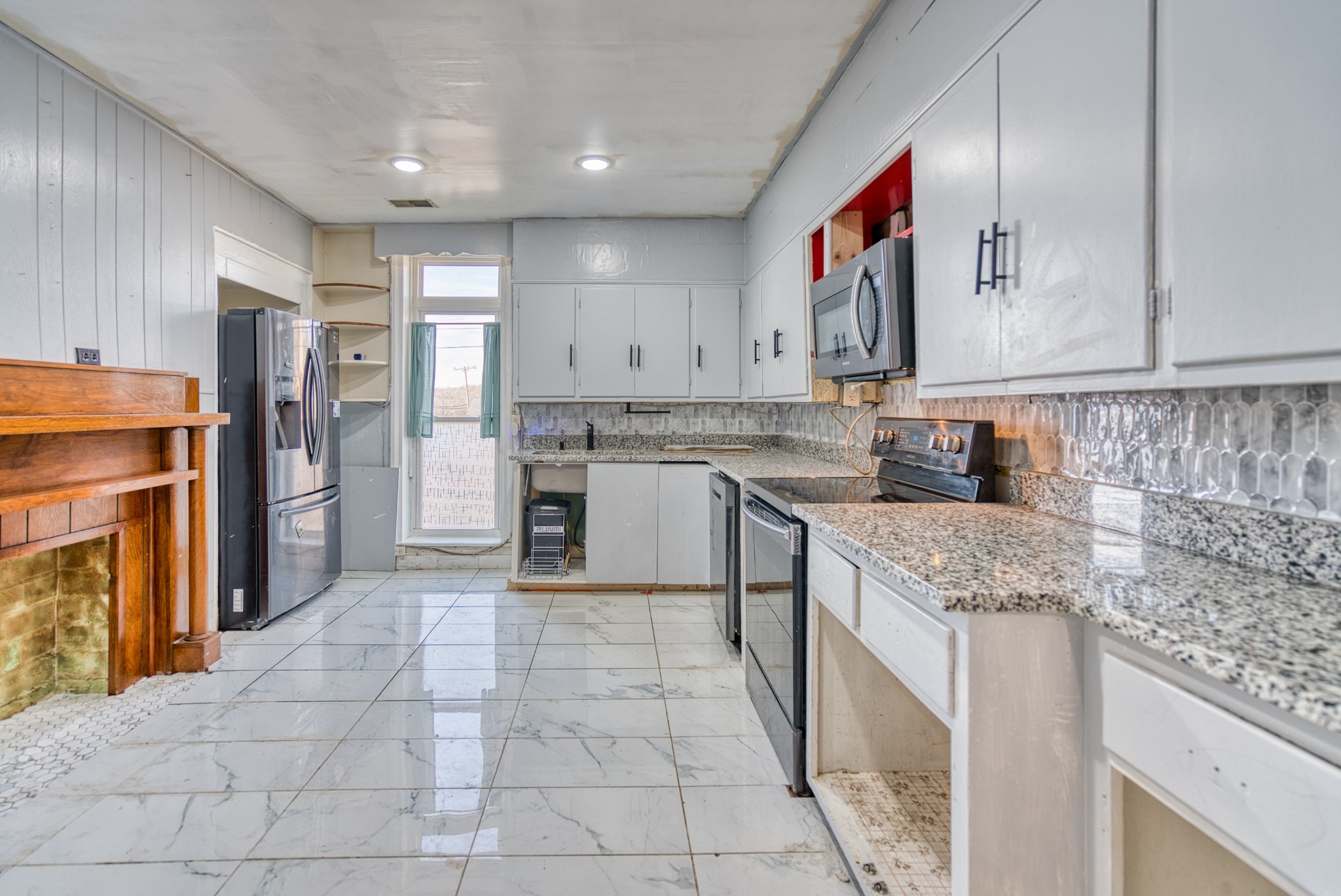 62 North Main Street Springfield, TN 37172 - Photo 15 of 69 a kitchen with a sink stove and refrigerator