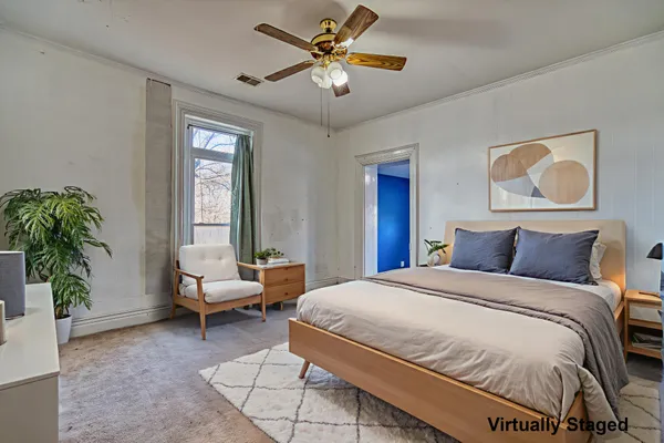 a bedroom with a large bed and a flat screen tv