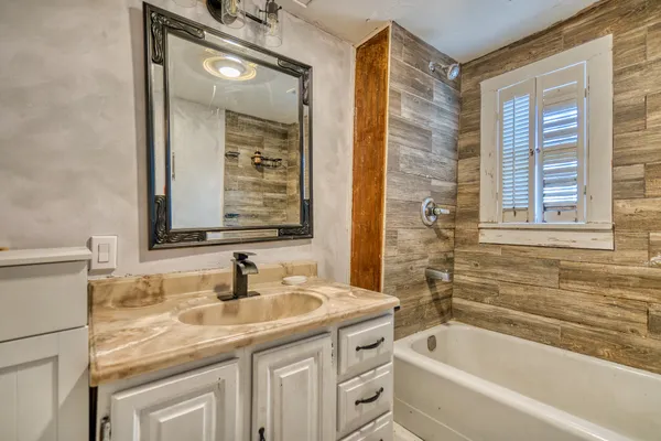 a bathroom with a sink and a mirror