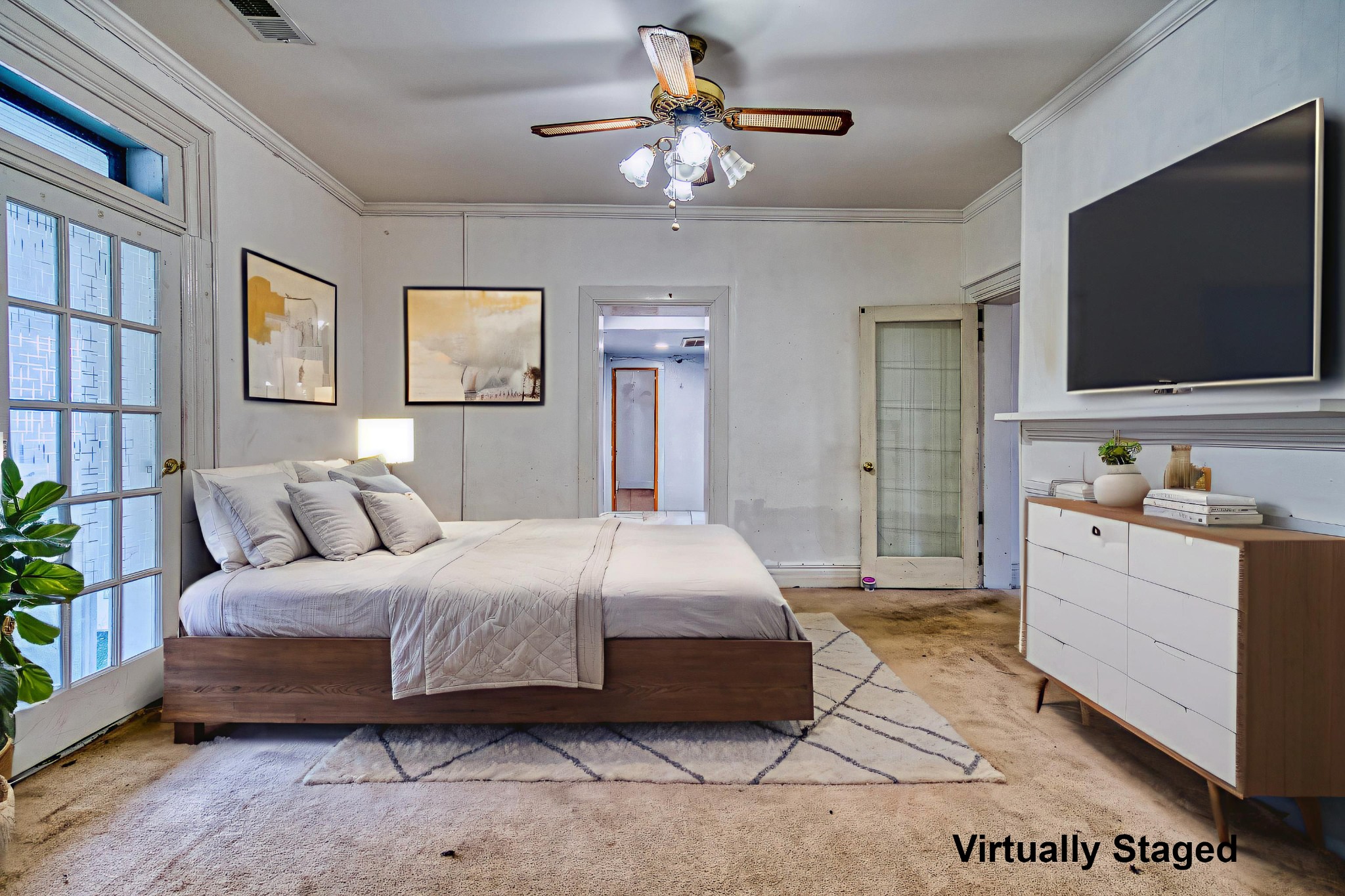 62 North Main Street Springfield, TN 37172 - Photo 31 of 69 a bedroom with a large bed a flat screen tv and a chandelier