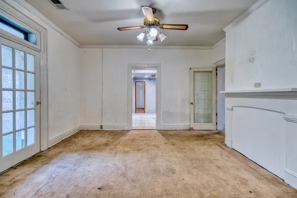an empty room with fireplace and windows