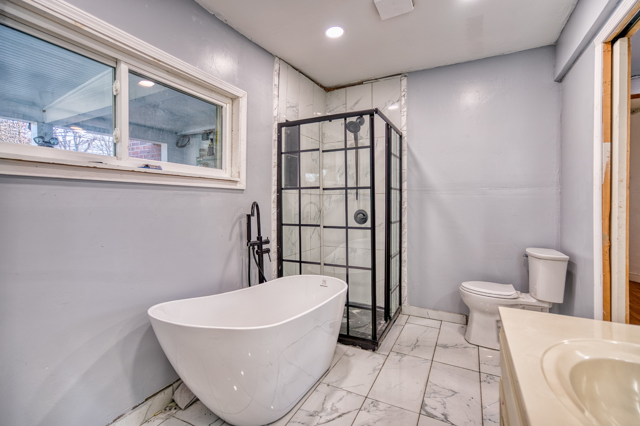 62 North Main Street Springfield, TN 37172 - Photo 37 of 69 a bathroom with a bathtub and a shower