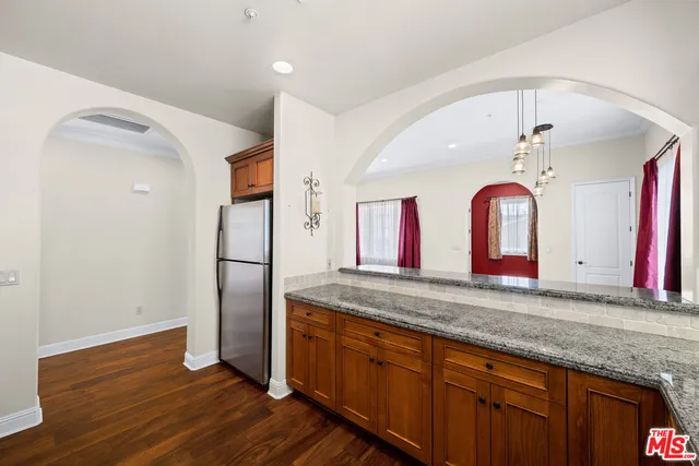 a view of a kitchen with stainless steel appliances granite countertop a refrigerator and a sink