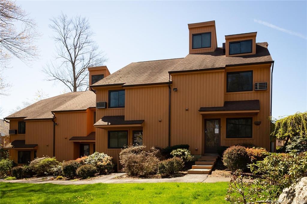 19 Woodway Road, Unit 4 Stamford, CT 06907 - Photo 1 of 1 a front view of a house with garden
