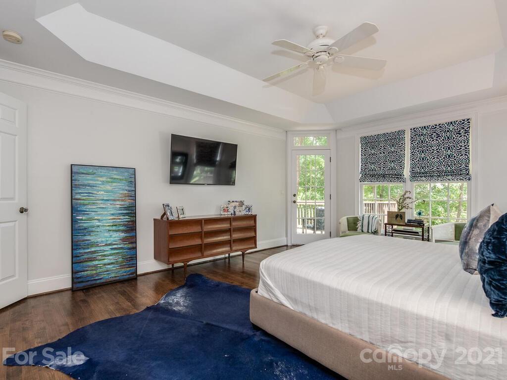 3025 Sharon Road Charlotte, NC 28211 - Photo 16 of 32 a bedroom with a bed and a flat screen tv