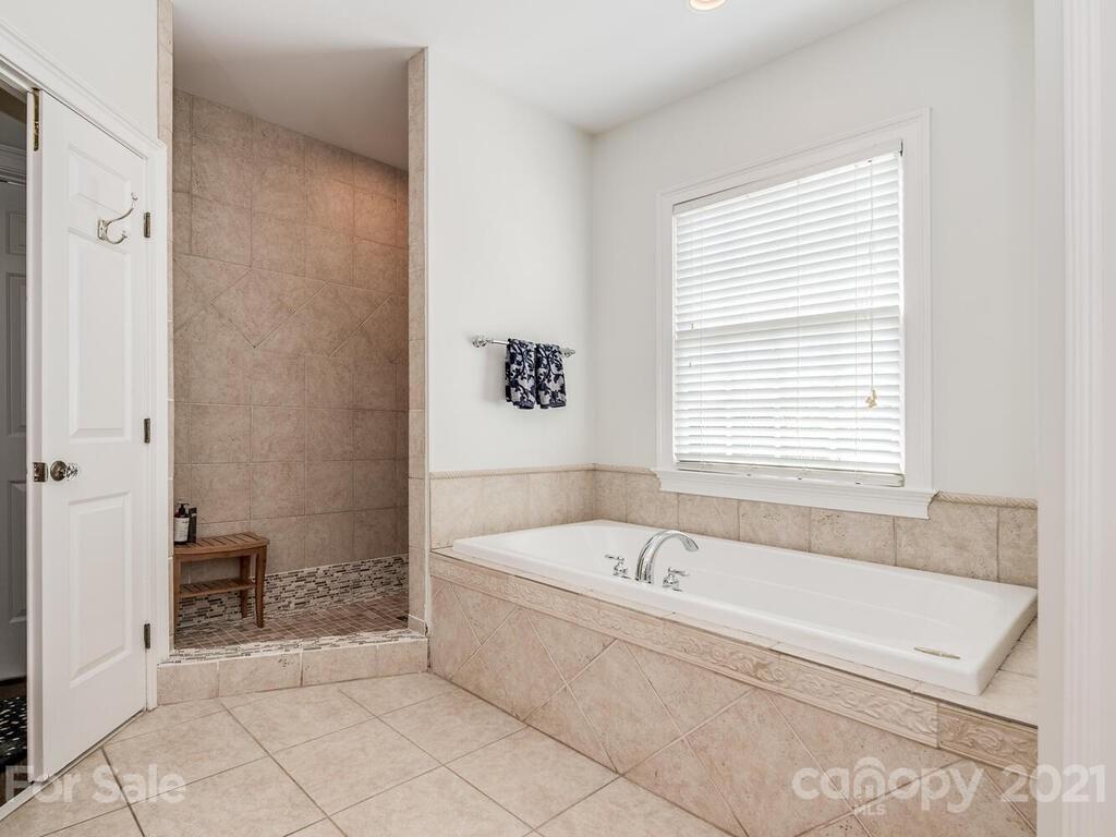 3025 Sharon Road Charlotte, NC 28211 - Photo 17 of 32 a bathroom with a bathtub and a shower