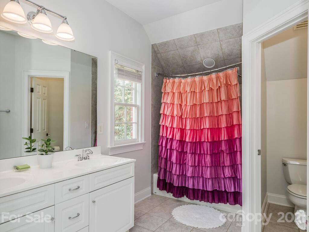 3025 Sharon Road Charlotte, NC 28211 - Photo 21 of 32 a bathroom with a sink toilet vanity and shower