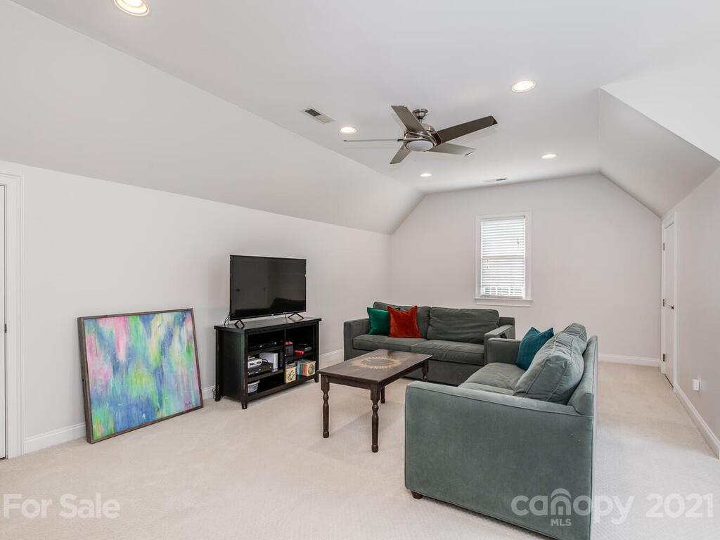 3025 Sharon Road Charlotte, NC 28211 - Photo 25 of 32 a living room with furniture and a flat screen tv
