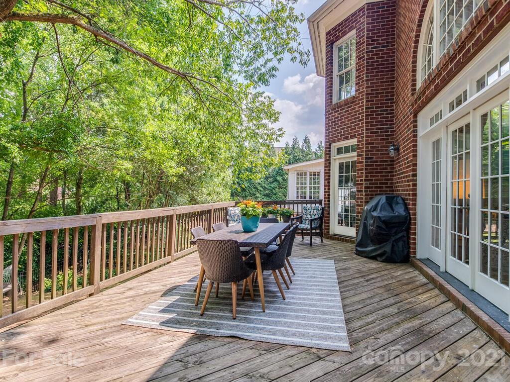 3025 Sharon Road Charlotte, NC 28211 - Photo 28 of 32 a view of a deck with table and chairs and wooden floor