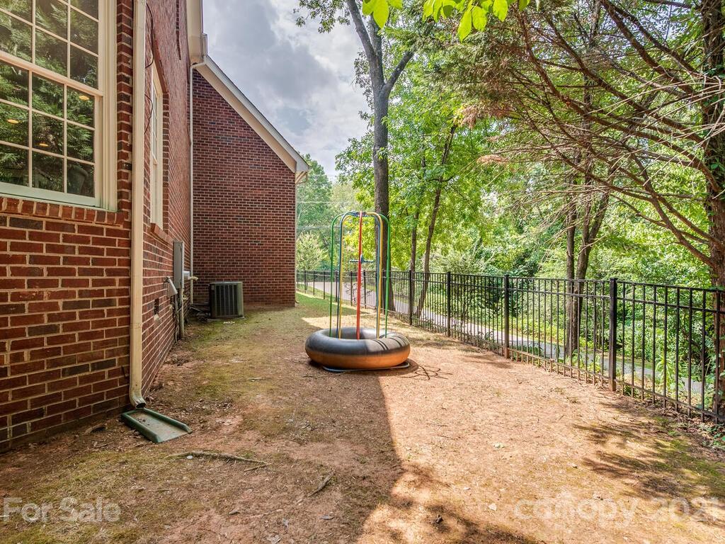 3025 Sharon Road Charlotte, NC 28211 - Photo 29 of 32 a backyard of a house with fountain table and chairs