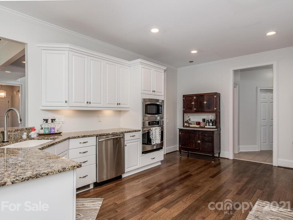 3025 Sharon Road Charlotte, NC 28211 - Photo 10 of 32 a kitchen with stainless steel appliances granite countertop a stove top oven a sink and a microwave
