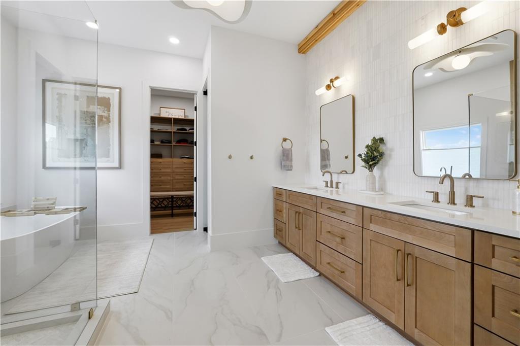 237 Lask Lane Milton, GA 30004 - Photo 39 of 63 a spacious bathroom with a double vanity sink a large mirror and a bathtub
