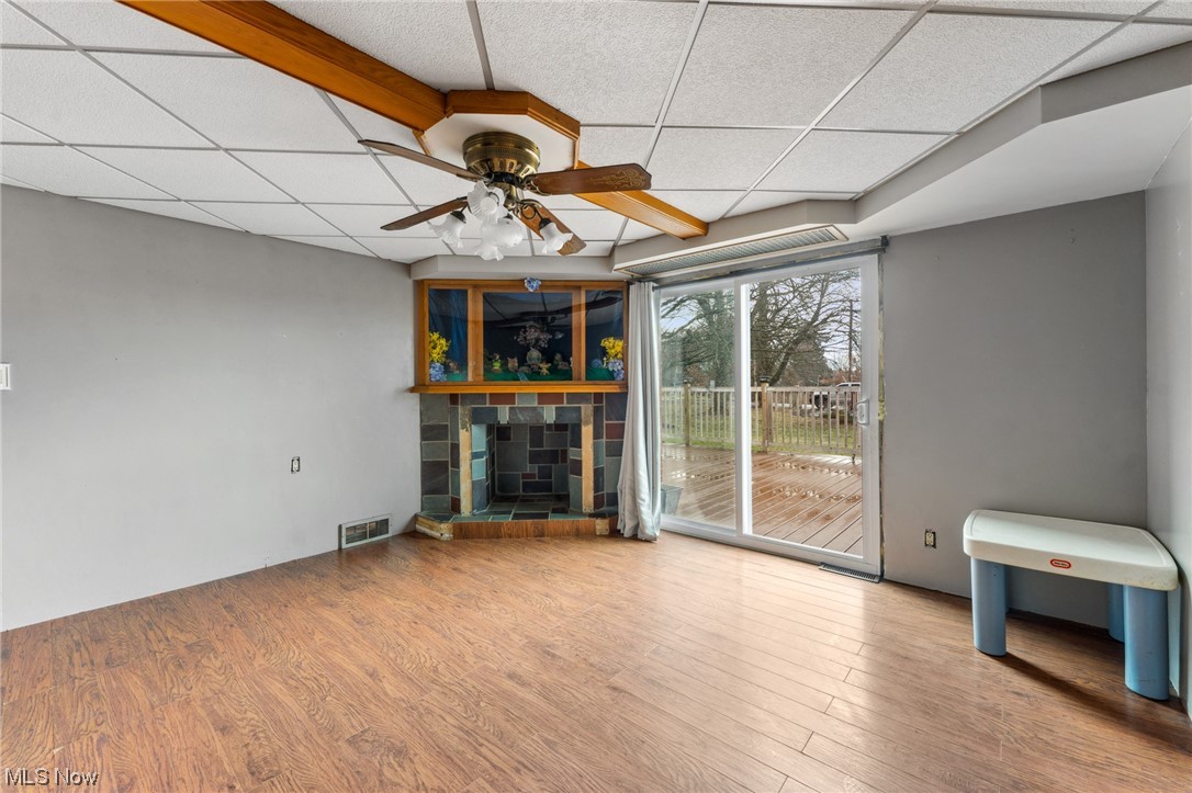 1470 Collar Price Road Hubbard, OH 44425 - Photo 8 of 23 Unfurnished living room featuring light hardwood / wood-style flooring, a paneled ceiling, and ceiling fan