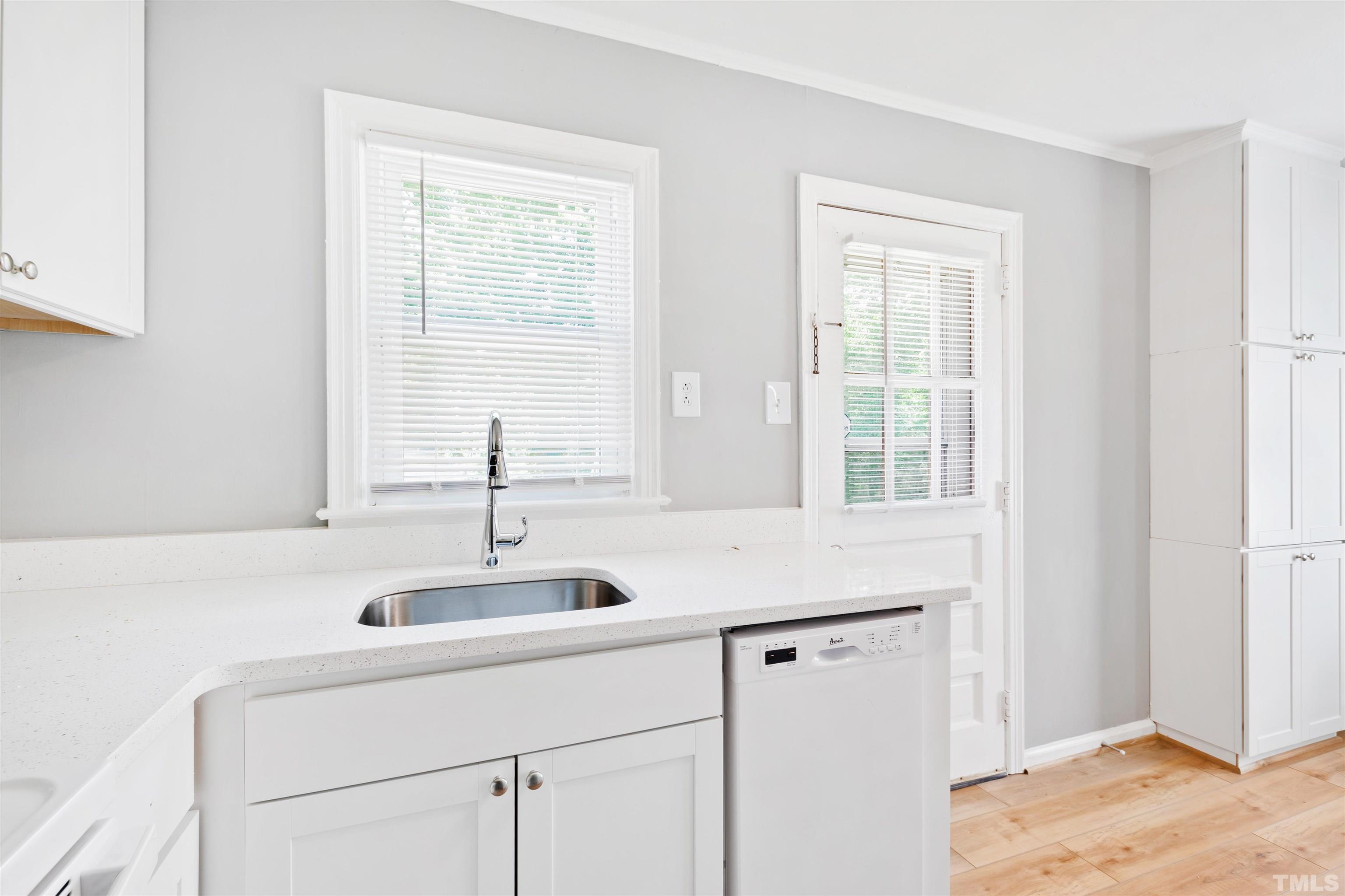 207 Baggett Avenue Raleigh, NC 27604 - Photo 14 of 27 a kitchen with a sink cabinets and a window