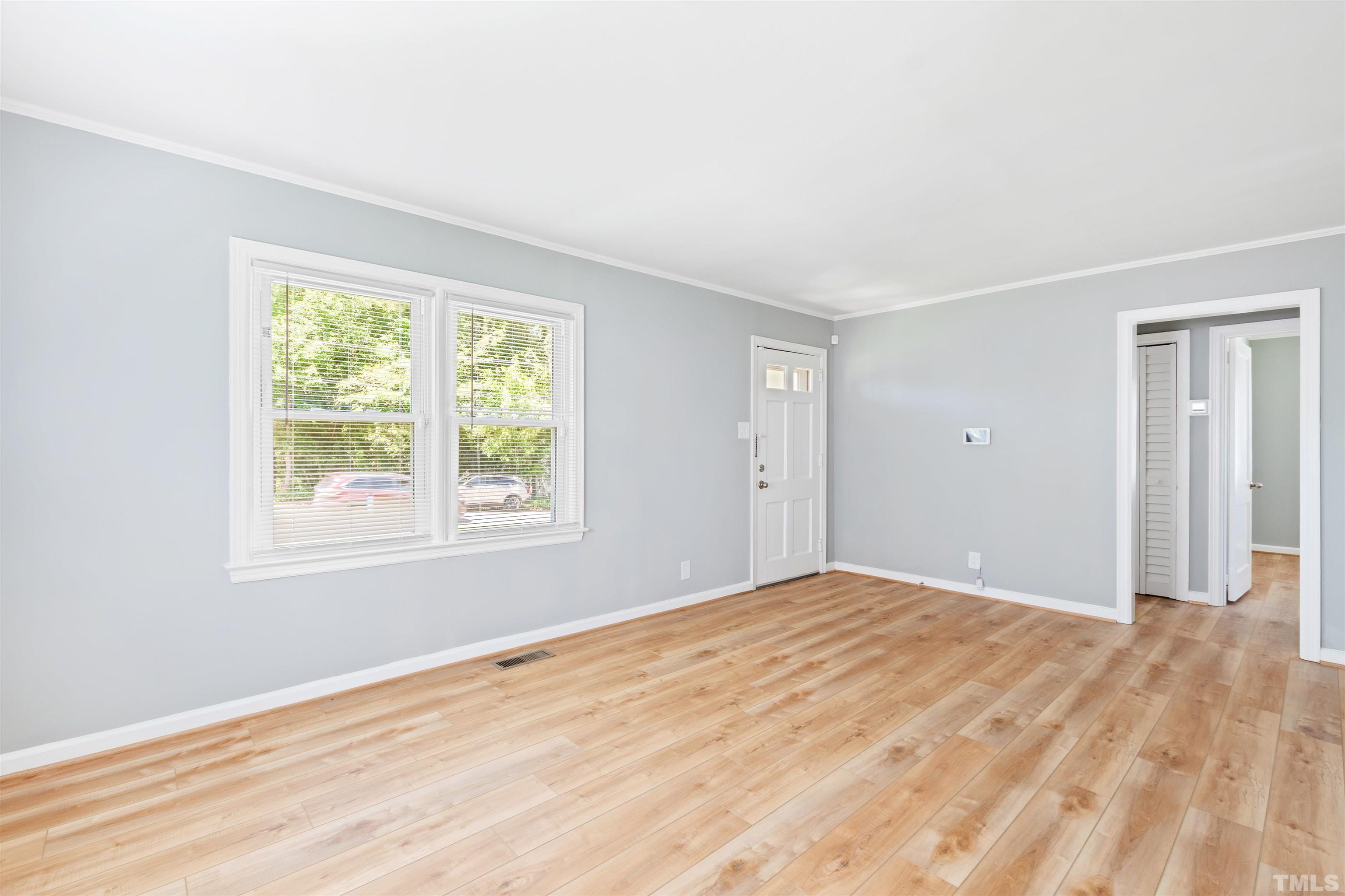 207 Baggett Avenue Raleigh, NC 27604 - Photo 17 of 27 a view of an empty room with wooden floor and a window