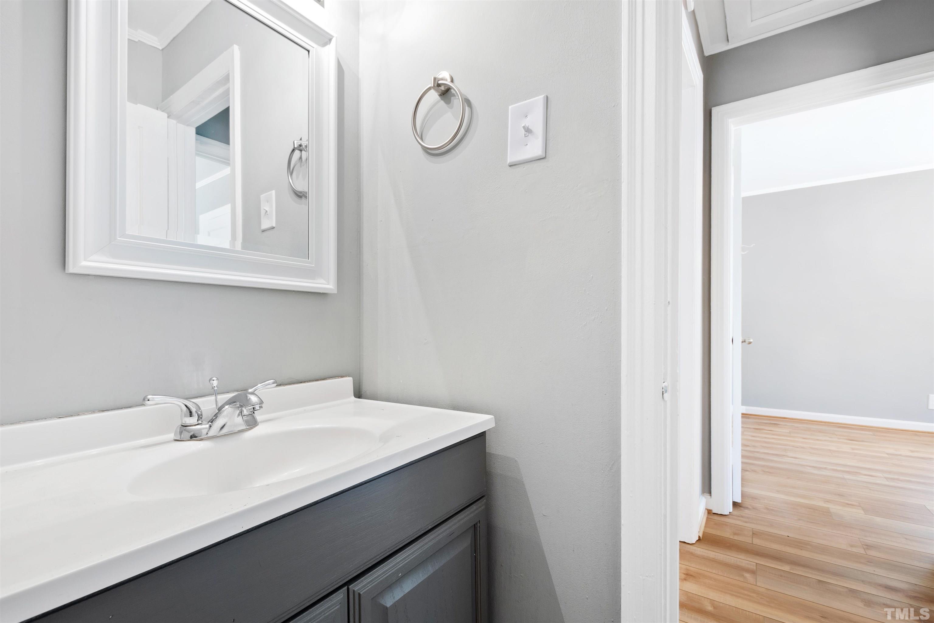 207 Baggett Avenue Raleigh, NC 27604 - Photo 23 of 27 a bathroom with a sink and a mirror