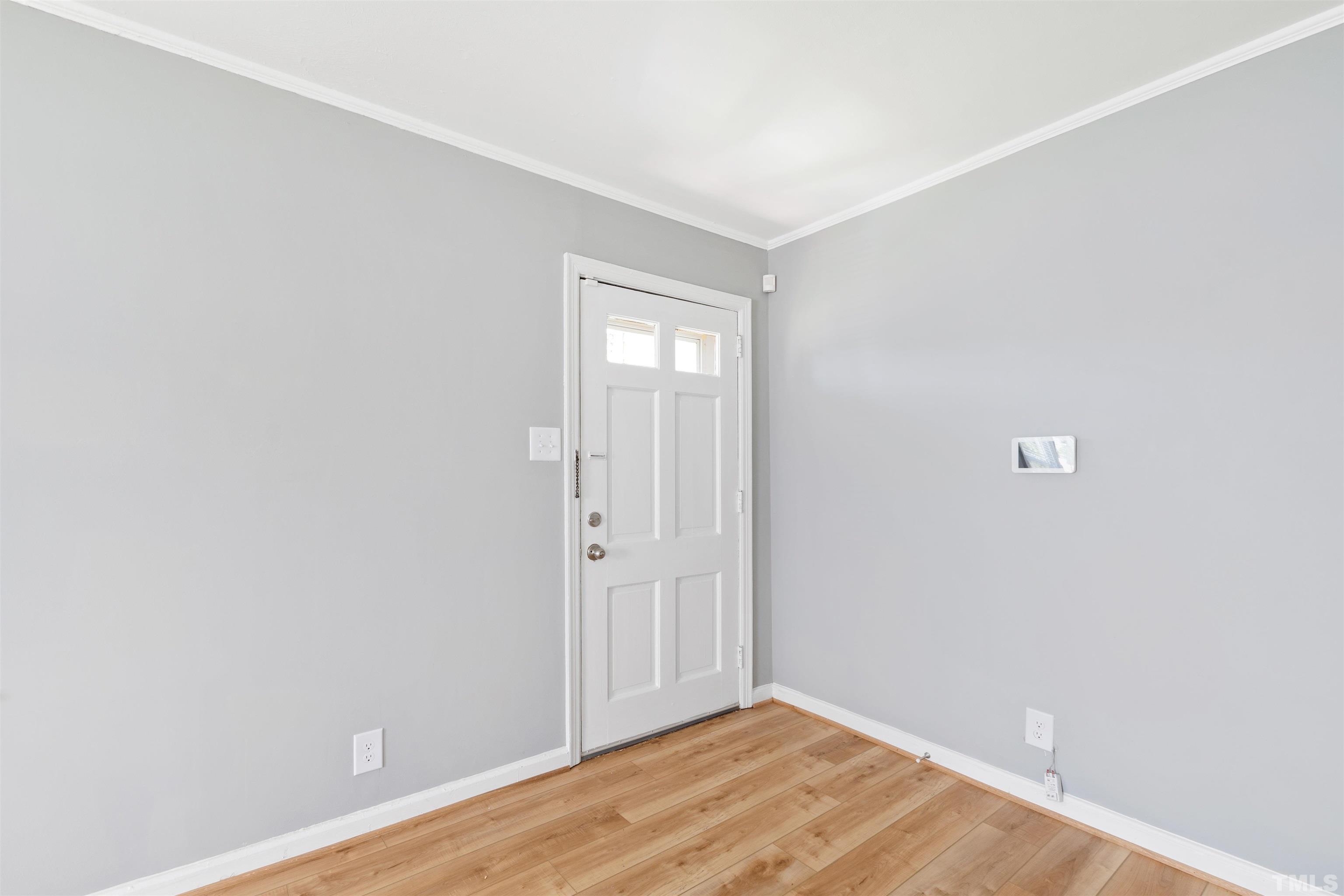 207 Baggett Avenue Raleigh, NC 27604 - Photo 6 of 27 a view of an empty room with wooden floor