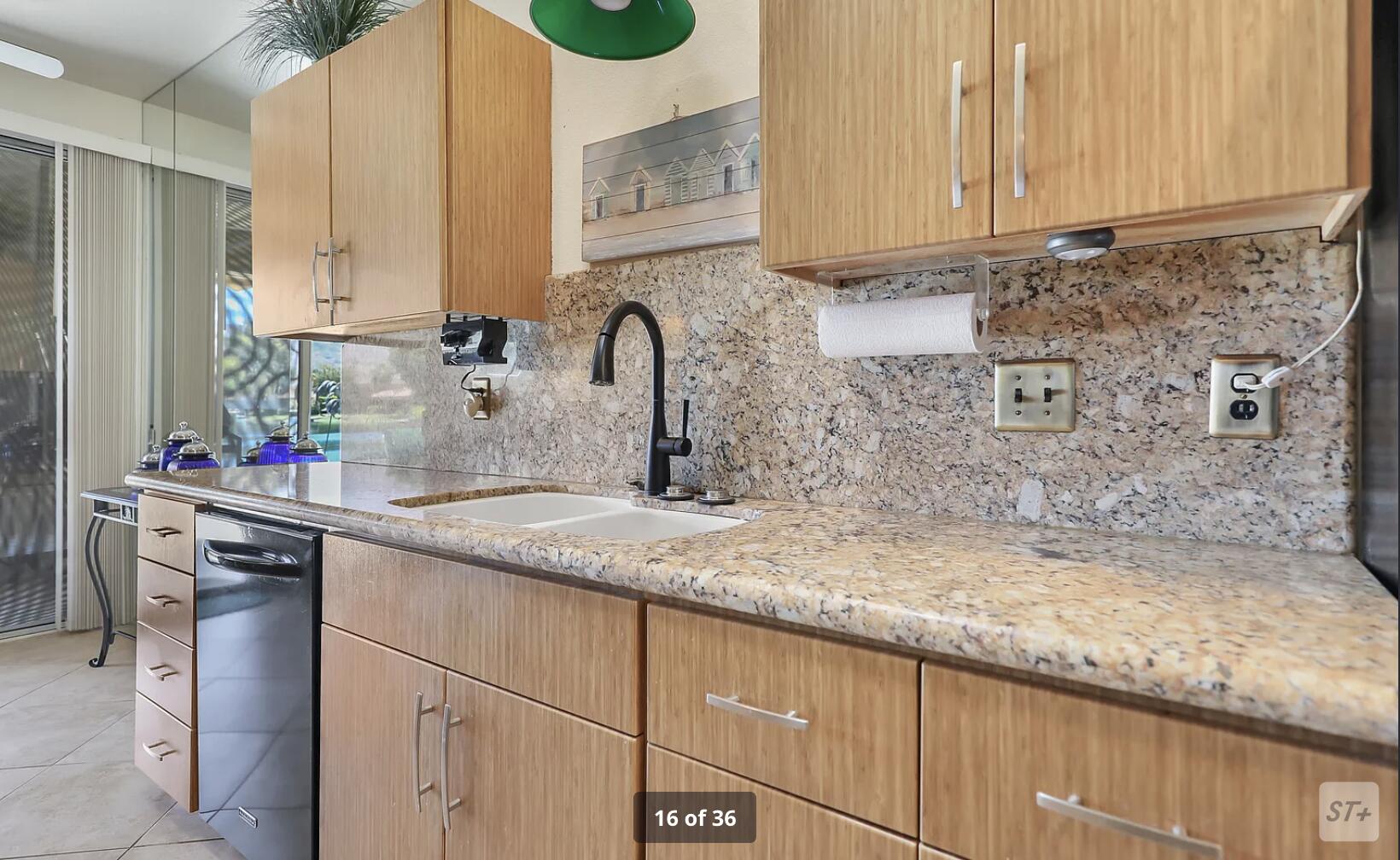 141 Lakeshore Drive Rancho Mirage, CA 92270 - Photo 16 of 34 a kitchen with granite countertop a sink a stove and cabinets
