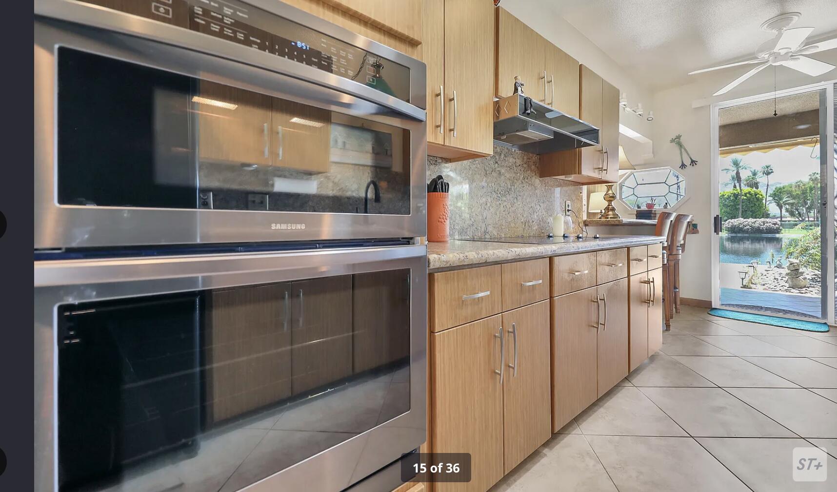 141 Lakeshore Drive Rancho Mirage, CA 92270 - Photo 19 of 34 a kitchen with stainless steel appliances granite countertop a stove and a microwave