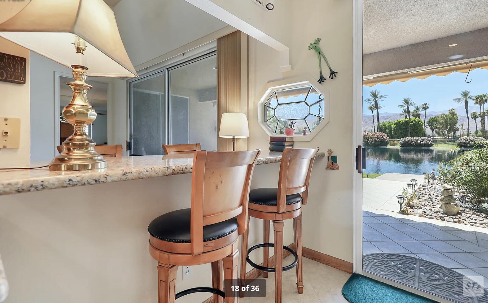 141 Lakeshore Drive Rancho Mirage, CA 92270 - Photo 22 of 34 a dining room with wooden floor furniture and a chandelier