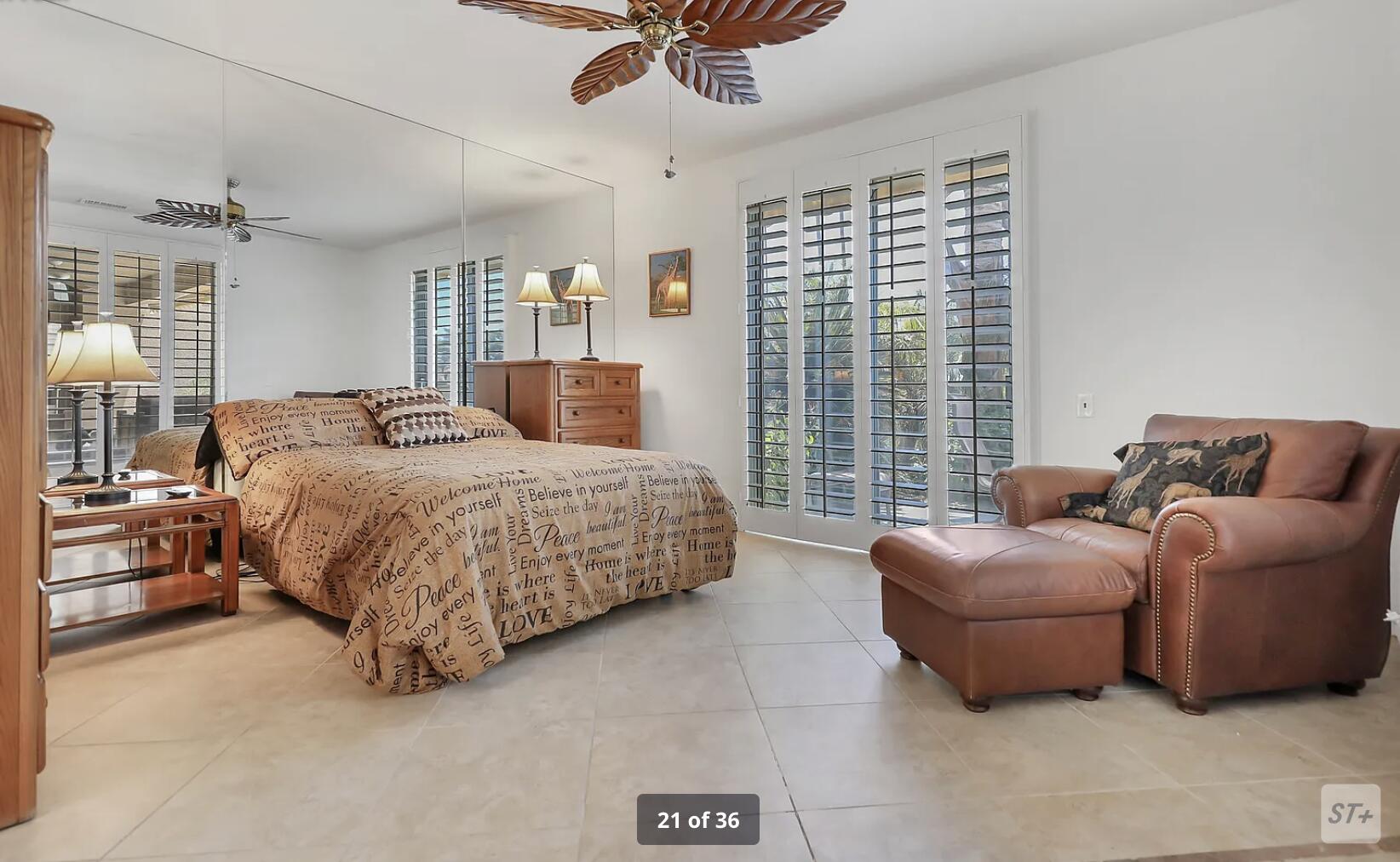 141 Lakeshore Drive Rancho Mirage, CA 92270 - Photo 23 of 34 a bedroom with a bed couch and window