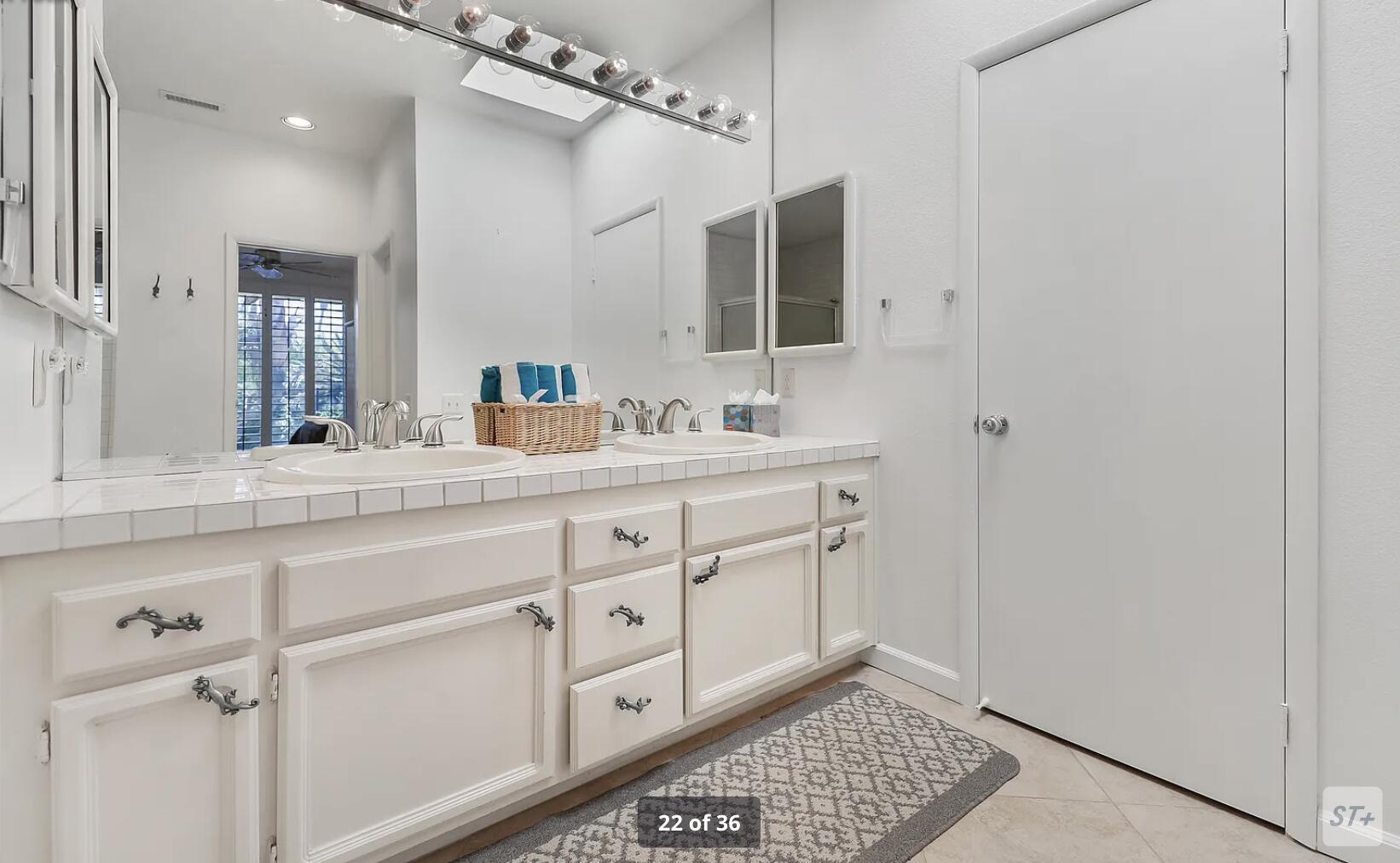 141 Lakeshore Drive Rancho Mirage, CA 92270 - Photo 25 of 34 a bathroom with a sink a mirror and a shower