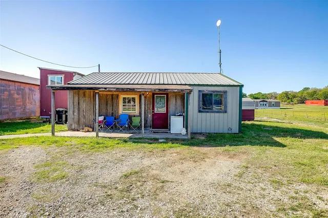 a view of a house with a yard and sitting area