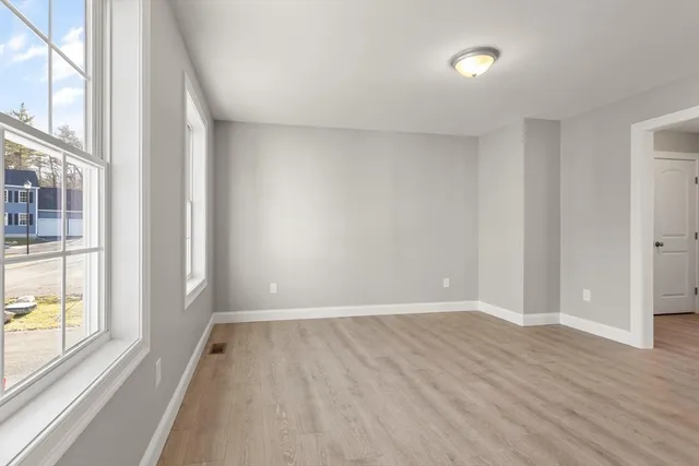 wooden floor in an empty room with a window