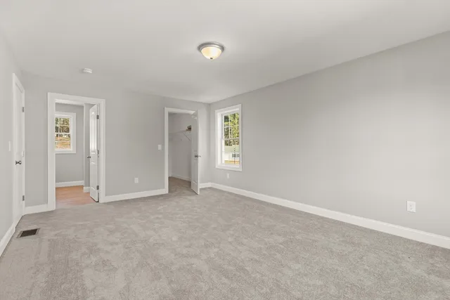 an empty room with windows and closet