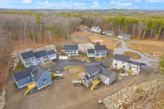 an aerial view of a swimming pool with outdoor seating