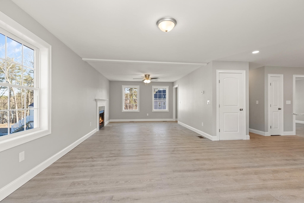 14 R Pne Hl Way, Unit 14 Harvard, MA 01451 - Photo 6 of 41 a view of an empty room with wooden floor and a window