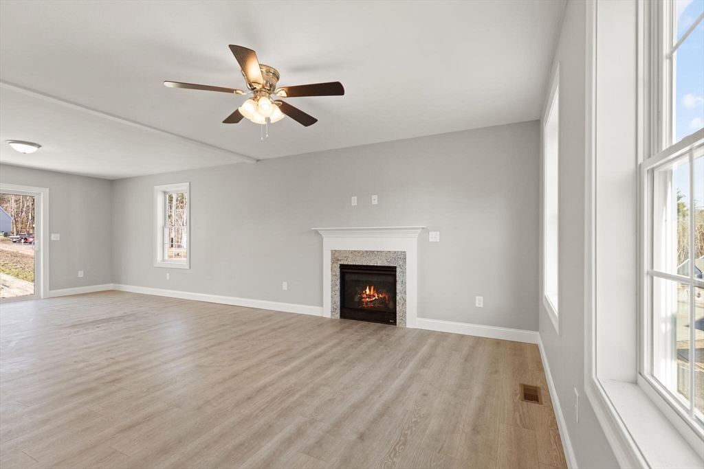 14 R Pne Hl Way, Unit 14 Harvard, MA 01451 - Photo 8 of 41 a view of an empty room with window and wooden floor