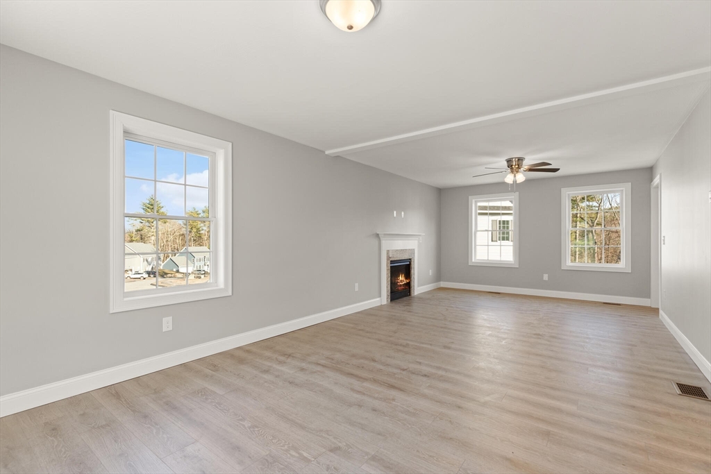 14 R Pne Hl Way, Unit 14 Harvard, MA 01451 - Photo 10 of 41 an empty room with wooden floor and windows