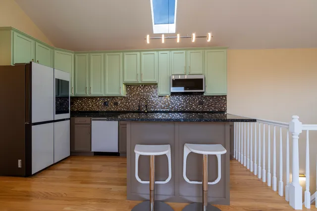 a stove top oven sitting inside of a kitchen