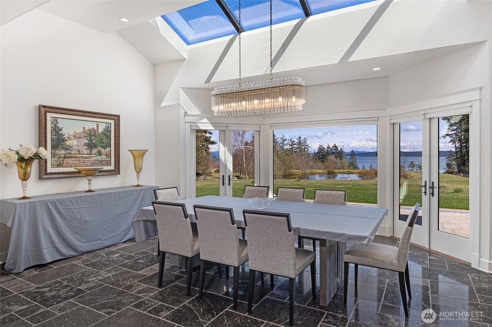 735 Rosler Road San Juan Island, WA 98250 - Photo 16 of 40 a view of a dining room with furniture wooden floor and chandelier